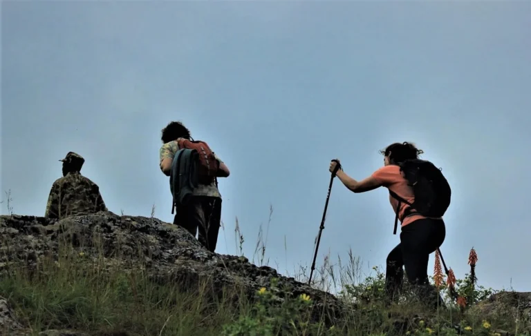 Hiker enjoying the scenic volcanic landscape during an acclimatization trek on Mount Kilimanjaro.
