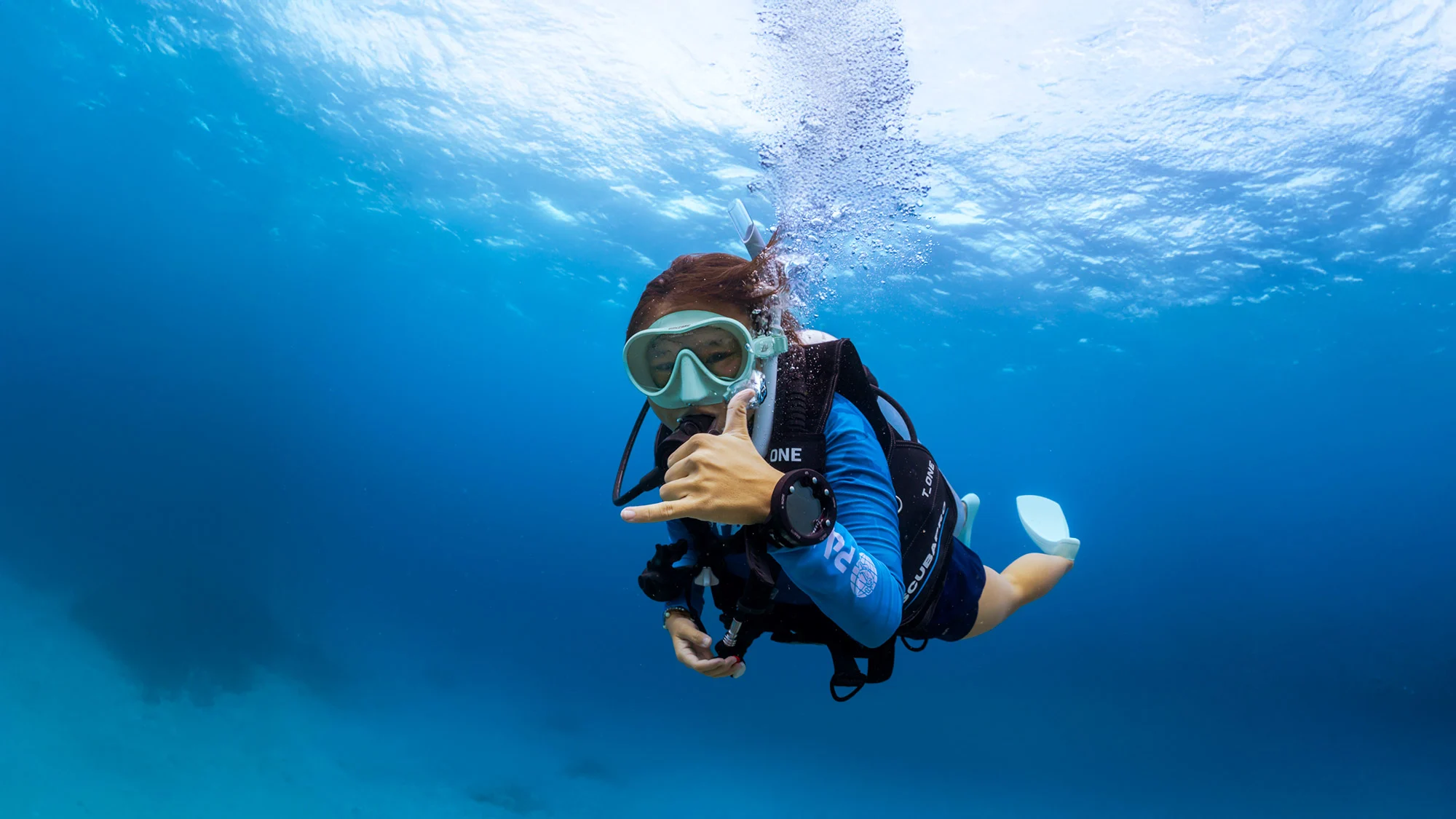 A scuba diver exploring a vibrant coral reef in the crystal clear waters off the coast of Zanzibar.