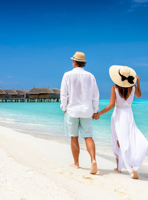 Happy,Couple,In,White,Clothing,And,With,Hats,Walks,Down