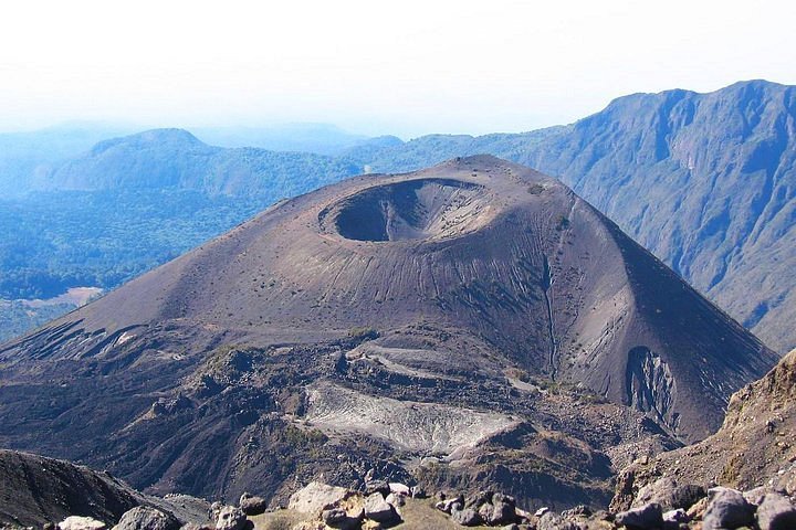 Stunning view of the rugged Mount Meru peak rising above the clouds in Tanzania.