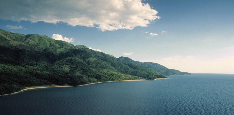 Scenic view of the deep blue waters and surrounding hills at Lake Tanganyika during a chimpanzee trekking safari.
